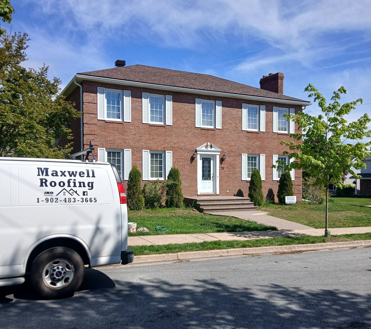 Maxwell Roofing branded van parked in front of a two-storey brick home in the Halifax area, Nova Scotia